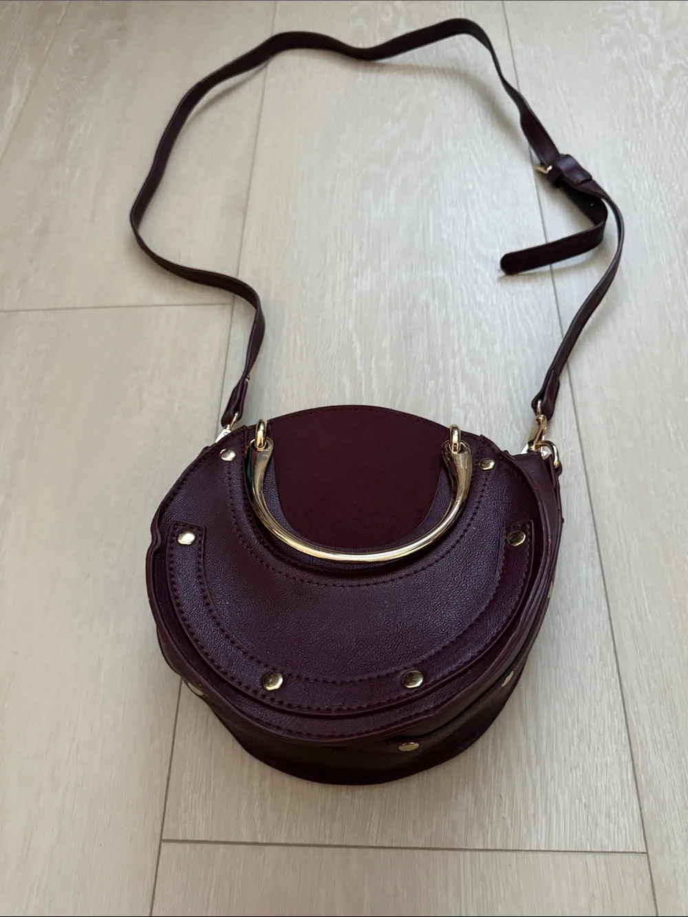 Round Crossbody Bag in Plum with Gold Accents